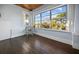 Bright sunroom featuring large windows, hardwood floors, and comfortable seating, perfect for relaxation at 609 W Osceola St, Clermont, FL 34711