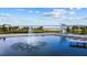 Scenic water feature with a central fountain, a pier, and lush landscaping, providing a serene park view at 609 W Osceola St, Clermont, FL 34711