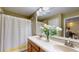 Large bathroom featuring double sinks, wood cabinets, neutral paint and a shower with bathtub at 6152 Meriwether, Winter Garden, FL 34787