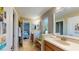 Double vanity bathroom connects to a bedroom with a doorway and hallway at 6152 Meriwether, Winter Garden, FL 34787
