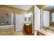 Bright bathroom with granite countertops, wood cabinets, mirror, and walk-in shower in the background at 6152 Meriwether, Winter Garden, FL 34787