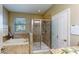 Elegant bathroom with soaking tub and separate glass-enclosed shower at 6152 Meriwether, Winter Garden, FL 34787