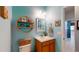 Bright bathroom featuring a sink with modern fixtures, wall decor and a decorative wicker shelf at 6152 Meriwether, Winter Garden, FL 34787