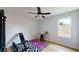 Simple bedroom area with a yoga mat, weight rack and ceiling fan at 6152 Meriwether, Winter Garden, FL 34787
