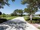 Enjoy a scenic path leading to a tranquil lake, surrounded by lush greenery and open spaces for relaxation and recreation at 6152 Meriwether, Winter Garden, FL 34787