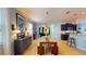 Open-concept dining area with a wooden table, bench seating, and dark kitchen cabinets at 6152 Meriwether, Winter Garden, FL 34787