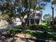 Charming home featuring a well-maintained lawn, mature trees, and a covered front porch at 6152 Meriwether, Winter Garden, FL 34787