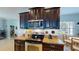 Kitchen features granite countertops, stainless oven and microwave and dark wood cabinets at 6152 Meriwether, Winter Garden, FL 34787
