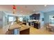 A bright open kitchen featuring a large island with breakfast bar and pendant lighting at 6152 Meriwether, Winter Garden, FL 34787