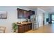 Kitchenette featuring granite counters, stainless refrigerator and dark wood cabinets at 6152 Meriwether, Winter Garden, FL 34787