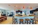 Modern kitchen with dark cabinets, stainless steel appliances, and a breakfast bar with stool seating at 6152 Meriwether, Winter Garden, FL 34787