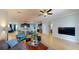 Open-concept living room featuring an eat-in kitchen, tiled floors, and comfortable seating at 6152 Meriwether, Winter Garden, FL 34787