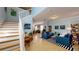 Bright and airy living room with a staircase, featuring neutral tones and ample natural light at 6152 Meriwether, Winter Garden, FL 34787