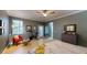 Spacious main bedroom features neutral paint, tiled floors, ceiling fan, and exercise bike at 6152 Meriwether, Winter Garden, FL 34787