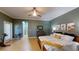 Spacious main bedroom features neutral paint, tiled floors, ceiling fan, and exercise bike at 6152 Meriwether, Winter Garden, FL 34787