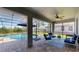 Screened patio with blue outdoor seating overlooking the pool and scenic lake views at 6152 Meriwether, Winter Garden, FL 34787