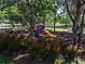 Neighborhood playground featuring a colorful playset, mature trees, and a safe, enclosed area for children to enjoy outdoor activities at 6152 Meriwether, Winter Garden, FL 34787