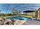 Sparkling screened-in pool with views of the lake offers a serene backyard retreat at 6152 Meriwether, Winter Garden, FL 34787