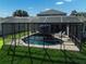 Backyard pool with black fencing surrounded by green grass at 6152 Meriwether, Winter Garden, FL 34787