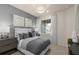 Cozy bedroom with accent wall, bedside lamps, and a large window with sheer curtains at 6324 Dew Drop Loop, St Cloud, FL 34771