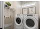 Laundry room equipped with a front load washer, front load dryer, and a built-in shelf at 6324 Dew Drop Loop, St Cloud, FL 34771