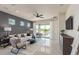 Cozy living room with plush seating, natural light, and access to the patio at 6324 Dew Drop Loop, St Cloud, FL 34771