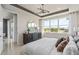 Serene main bedroom featuring a large window, neutral tones, and a dresser at 6324 Dew Drop Loop, St Cloud, FL 34771