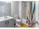 Clean, well-lit bathroom with shower-tub combo, colorful curtain, and ample vanity space at 6874 Sperone St, Orlando, FL 32819