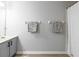 Bathroom vanity with grey cabinets and neutral towels hanging on the wall at 6874 Sperone St, Orlando, FL 32819