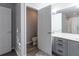 Bathroom featuring gray cabinets, a double vanity, a toilet room and a shower and tub combination at 6874 Sperone St, Orlando, FL 32819