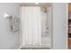 Clean bathroom features a shower with a white shower curtain and a grey towel at 6874 Sperone St, Orlando, FL 32819
