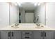 Double sink vanity bathroom features a large mirror and neutral colored walls at 6874 Sperone St, Orlando, FL 32819