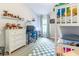 Bright bedroom with bunkbeds, desk, and shelving for toys and books at 6874 Sperone St, Orlando, FL 32819