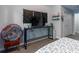 Bedroom features stylish desk with a dark metal frame, decorative wall art, and a patterned duvet cover at 6874 Sperone St, Orlando, FL 32819