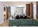 Dining area flows into kitchen and living area with wood floors and sliding barn door to side at 6874 Sperone St, Orlando, FL 32819