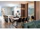 An open-concept dining area with modern lighting and adjacent kitchen with marble counter tops at 6874 Sperone St, Orlando, FL 32819