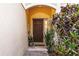 A welcoming front door framed by lush plants, creating an inviting entrance at 6874 Sperone St, Orlando, FL 32819