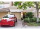 Charming townhome featuring a one-car garage, complemented by lush landscaping at 6874 Sperone St, Orlando, FL 32819