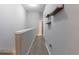 Upstairs hallway with wood floors, modern floating shelves, and a view of a closet at 6874 Sperone St, Orlando, FL 32819