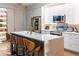 Modern kitchen with stainless steel appliances, a breakfast bar, and sleek countertops at 6874 Sperone St, Orlando, FL 32819