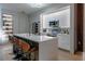 Contemporary kitchen featuring a large island with seating, modern appliances, and sleek white cabinetry at 6874 Sperone St, Orlando, FL 32819