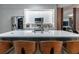 Modern kitchen with a large island, stainless steel appliances, and sleek white cabinets; open layout at 6874 Sperone St, Orlando, FL 32819