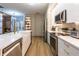 Modern kitchen with stainless steel appliances, a breakfast bar, and sleek countertops at 6874 Sperone St, Orlando, FL 32819