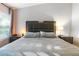 Comfortable main bedroom featuring a large padded headboard and a bright window at 6874 Sperone St, Orlando, FL 32819