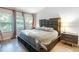 Comfortable main bedroom featuring a large padded headboard and a bright window at 6874 Sperone St, Orlando, FL 32819