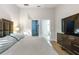 Spacious bedroom features a door leading to the bathroom and a closet at 6874 Sperone St, Orlando, FL 32819