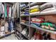 Well-organized walk-in closet featuring shelving for folded clothes, shoes, and hanging garments at 6874 Sperone St, Orlando, FL 32819