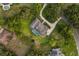 Aerial view of a house with a swimming pool, lush landscaping, and a curved driveway at 8368 Rambling River Dr, Sanford, FL 32771