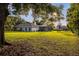 Expansive backyard featuring lush greenery, a screened-in pool area, and ample space for outdoor activities and relaxation at 8368 Rambling River Dr, Sanford, FL 32771