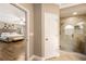 Modern bathroom with a glass-enclosed shower, tile floors, and view of the main bedroom at 8368 Rambling River Dr, Sanford, FL 32771